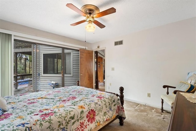 carpeted bedroom featuring ceiling fan and access to exterior