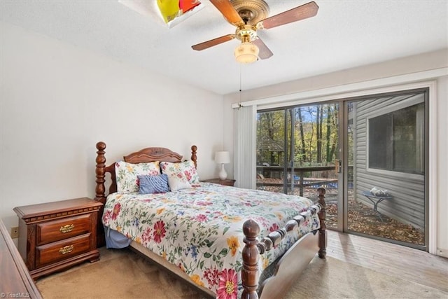 bedroom featuring access to exterior, light wood-type flooring, and ceiling fan