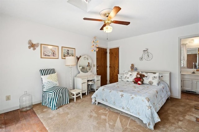 bedroom featuring hardwood / wood-style flooring, ensuite bath, and ceiling fan