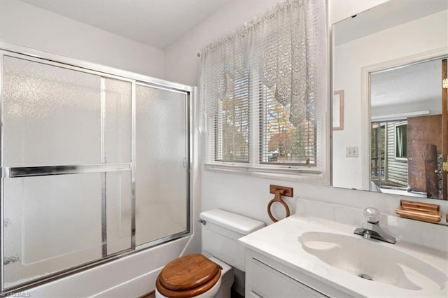 full bathroom with toilet, combined bath / shower with glass door, and vanity