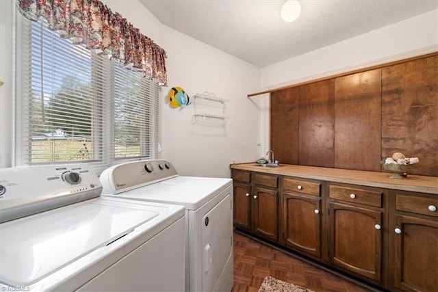 laundry room with cabinets, sink, independent washer and dryer, and dark parquet floors