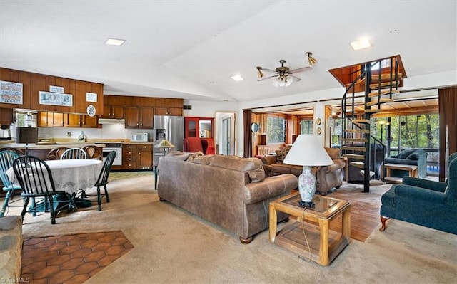 living room featuring lofted ceiling, light colored carpet, and ceiling fan