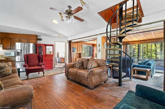 living room with light hardwood / wood-style floors, plenty of natural light, lofted ceiling, and ceiling fan