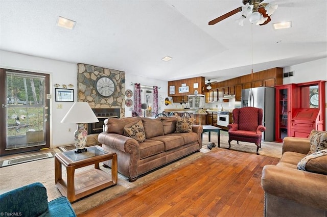 living room with light hardwood / wood-style floors and ceiling fan