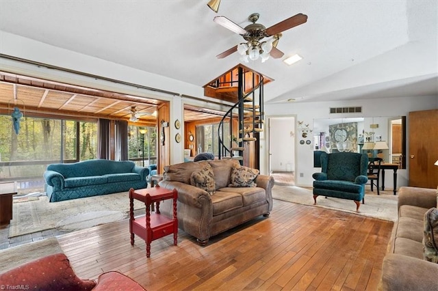 living room featuring light wood-type flooring, lofted ceiling, and ceiling fan