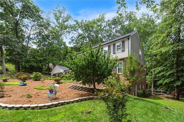 view of front of home with a front yard, brick siding, and fence