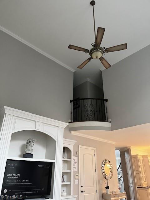 interior details featuring crown molding and ceiling fan