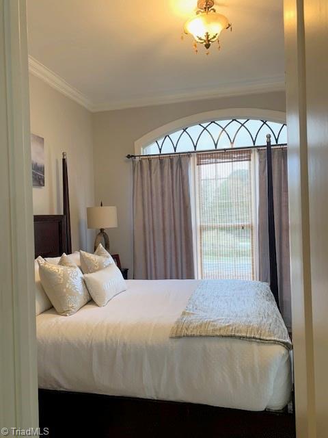 bedroom with crown molding