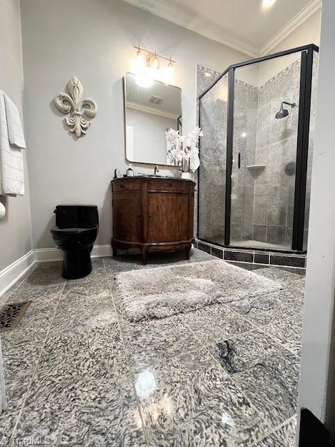 bathroom with vanity, toilet, crown molding, and a shower with door