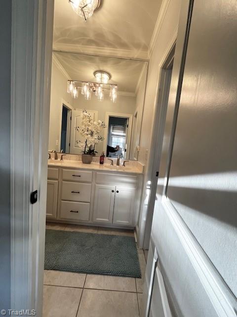 bathroom featuring vanity, crown molding, and tile patterned flooring