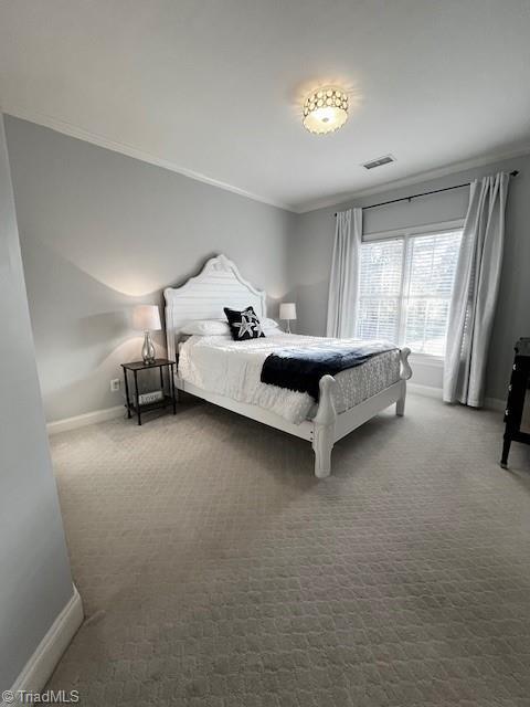 carpeted bedroom featuring crown molding