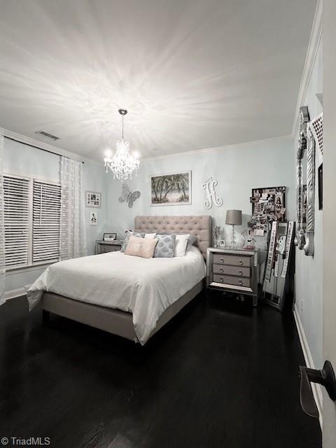 bedroom with crown molding and dark hardwood / wood-style floors