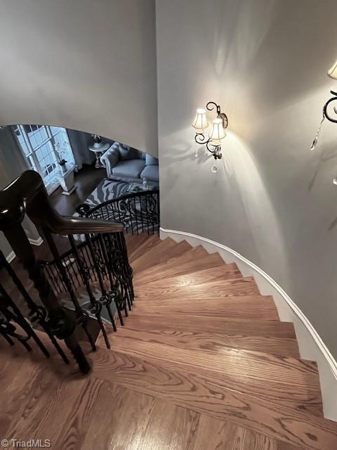 stairs featuring wood-type flooring