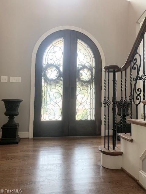 entrance foyer featuring french doors and hardwood / wood-style floors