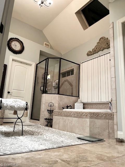 bathroom with an enclosed shower and lofted ceiling