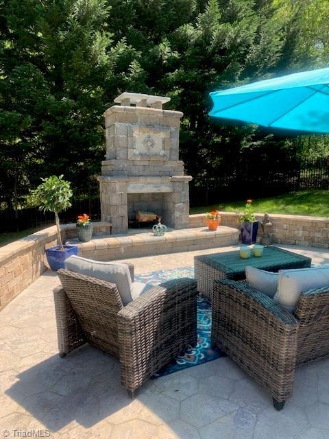 view of patio with an outdoor stone fireplace