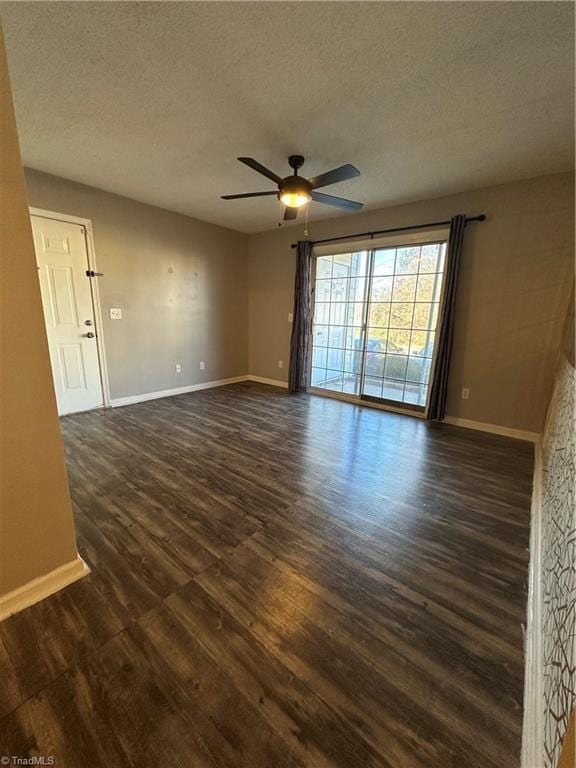 empty room featuring a textured ceiling, dark hardwood / wood-style flooring, and ceiling fan