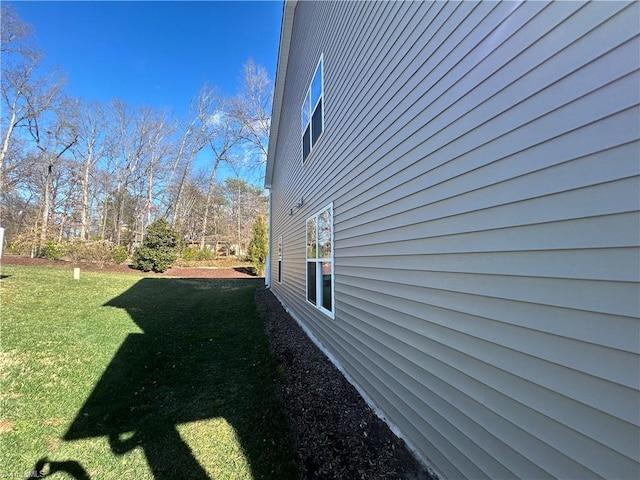 view of side of property with a yard