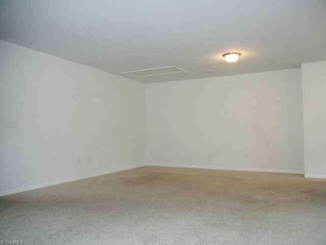 carpeted spare room with baseboards