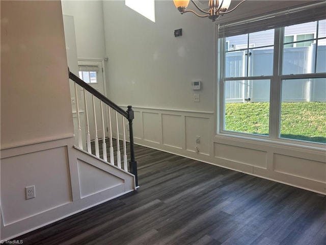 foyer with a healthy amount of sunlight, stairs, and a decorative wall