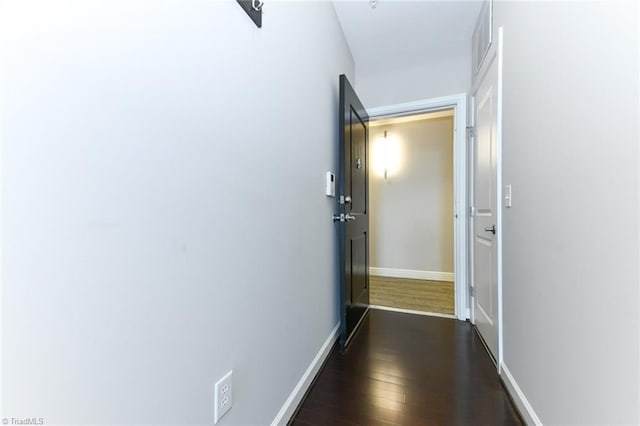 hallway featuring dark hardwood / wood-style flooring