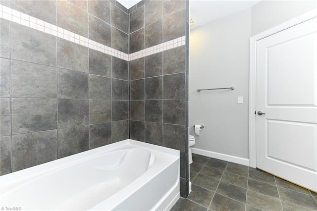 bathroom featuring tile patterned floors, bathtub / shower combination, and toilet