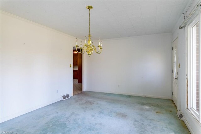 carpeted empty room featuring an inviting chandelier, crown molding, and plenty of natural light