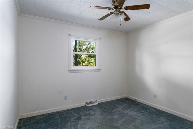 empty room with ornamental molding, dark carpet, and ceiling fan