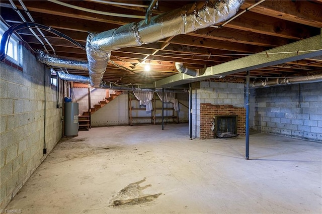 basement with a brick fireplace and water heater