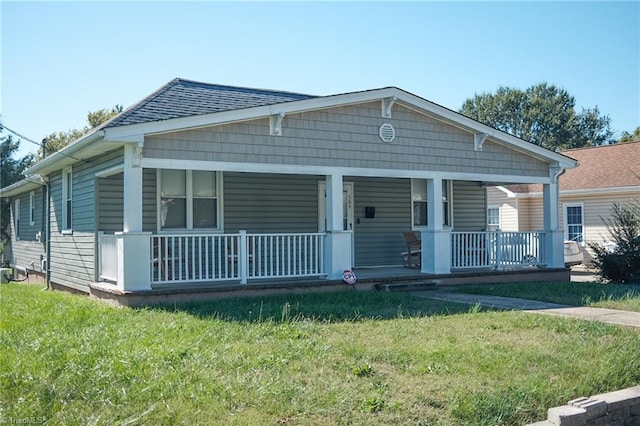 view of front facade featuring a front lawn and covered porch