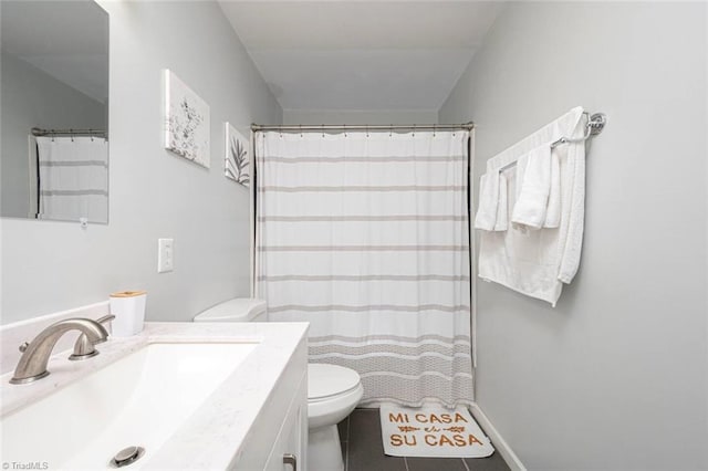 bathroom with a shower with curtain, vanity, toilet, and tile patterned floors