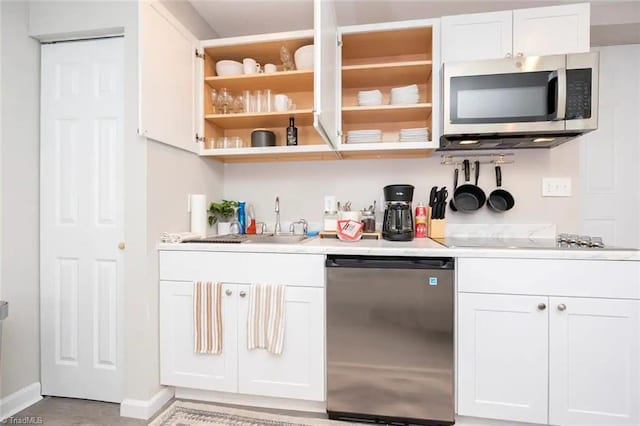 bar with stainless steel appliances, white cabinets, and sink