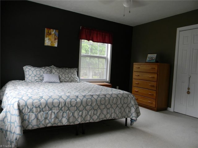 bedroom featuring ceiling fan and light colored carpet