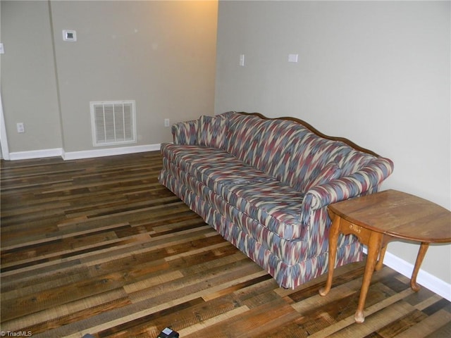 living room with baseboards, wood finished floors, and visible vents