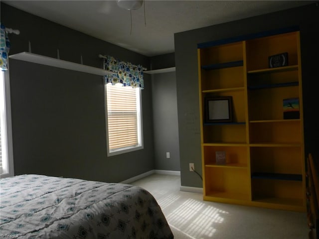 bedroom featuring ceiling fan and light colored carpet