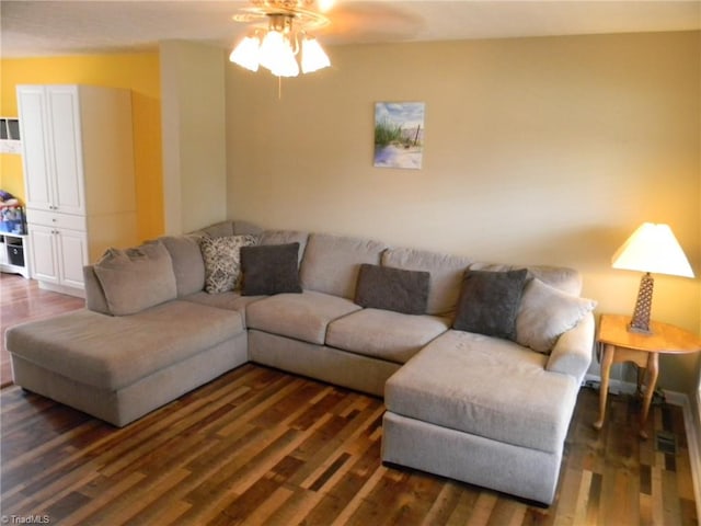 living room featuring dark hardwood / wood-style floors and ceiling fan