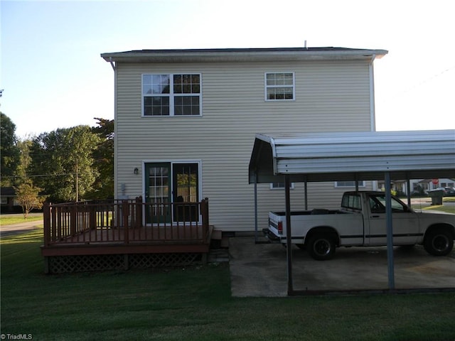 back of house featuring a wooden deck, a lawn, and a carport