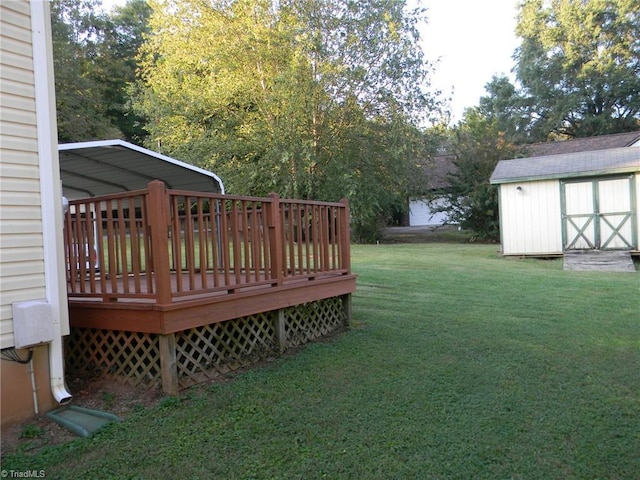 view of yard featuring a carport, a deck, an outdoor structure, and a shed
