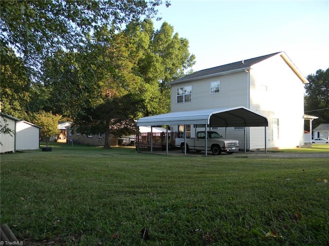 rear view of property with a storage shed, a carport, and a yard