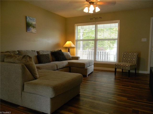 living room featuring dark hardwood / wood-style flooring and ceiling fan