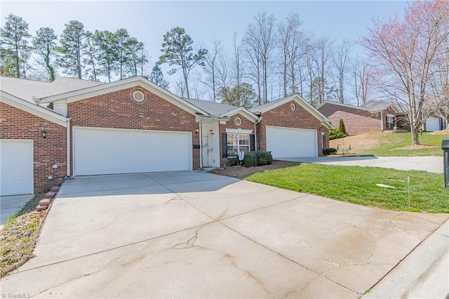 single story home with concrete driveway, a garage, brick siding, and a front yard