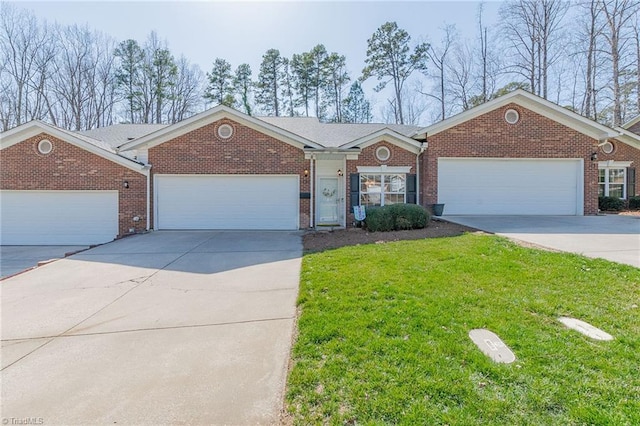 single story home with brick siding, concrete driveway, a garage, and a front yard