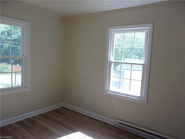 empty room with plenty of natural light and a baseboard heating unit