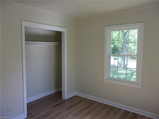 unfurnished bedroom featuring a closet and dark hardwood / wood-style flooring