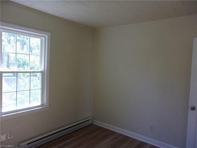 empty room featuring dark hardwood / wood-style flooring and a baseboard radiator