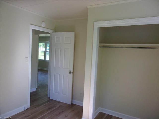 unfurnished bedroom featuring a closet and dark hardwood / wood-style floors