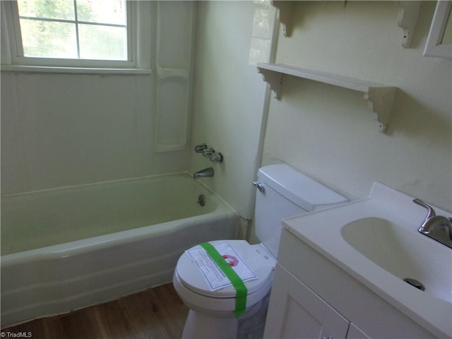 full bathroom with shower / bath combination, vanity, hardwood / wood-style flooring, and toilet