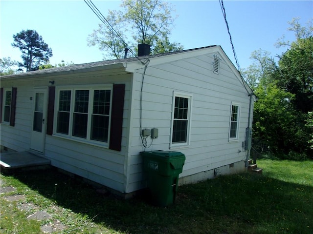 view of home's exterior with a yard