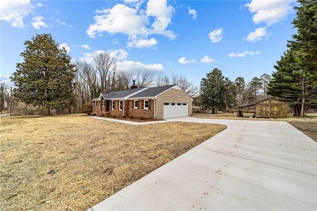view of front of property with an attached garage, driveway, and a chimney
