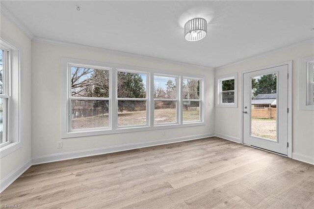 unfurnished sunroom with a chandelier and a healthy amount of sunlight